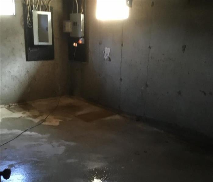 A severely flooded basement finally has most standing water removed from the walls and concrete floor