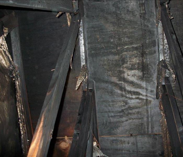 charred rafters in attic